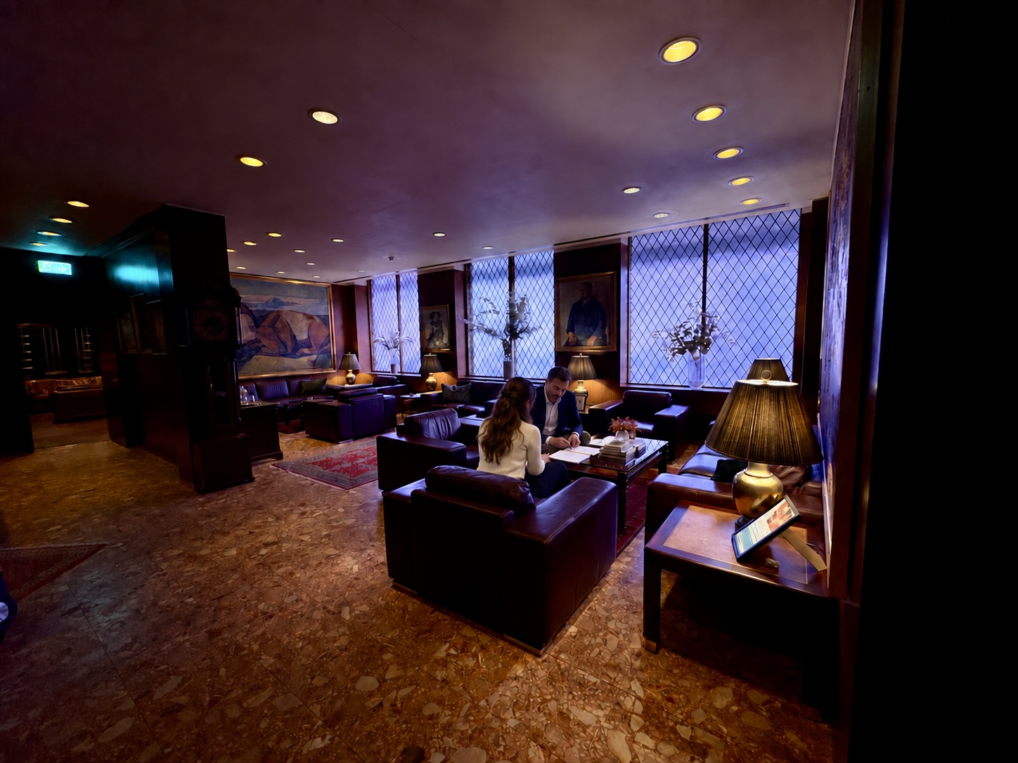 A consultant and business owner reviewing a plan together in a lounge